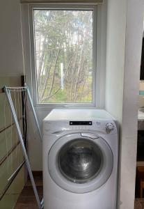a washing machine in a room with a window at Casa de Ushuaia in Ushuaia