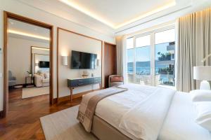 a bedroom with a large bed and a large window at Porto Montenegro Residence Elena in Tivat