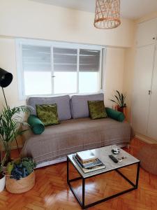 a living room with a couch and a table at Exclusivo y luminoso Estudio c/Balcón in Buenos Aires