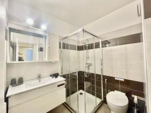 a bathroom with a shower and a toilet and a sink at Arènes by Welcome to Cannes in Cannes