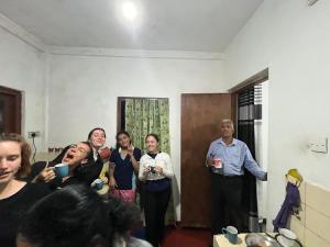 a group of people standing in a room at Green Villa in Nuwara Eliya