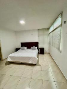 a bedroom with a bed and a tiled floor at Casas Bote in El Morro de Barcelona
