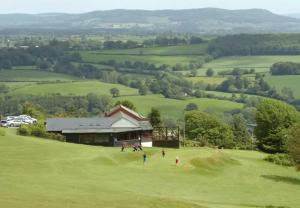 a group of people playing golf on a green at Vast, Elegant Home with Indoor Pool & Sauna near Popular Golf Course in Kington