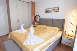 a bedroom with two beds with white towels on them at New Modern & Cozy apartment with FREE Private parking and EV charging station in Varna City