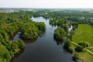 an aerial view of a river with trees and water at Glamping Borken in Borken