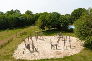 an empty playground in a park with trees at Glamping Borken in Borken