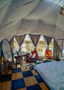 a room with a tent with a table and chairs at Chateau Vartsikhe in Varts'ikhe