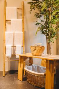 a bathroom with a table and a shelf with towels at Cabanas do Pico 2B in Canto da Areia