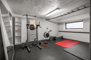 a room with a gym with a treadmill and weights at Apartment with Private Balcony and Flexible Check In in Bergen