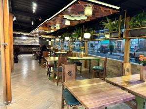 a restaurant with wooden tables and chairs and people at Chakana Hotel Boutique Mariscal in Quito
