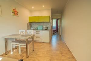 a kitchen with a table and chairs in a room at Ostoja in Turawa +5 photos