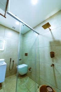 a bathroom with a glass shower and a toilet at Hotel ROYAL STAY in Thanjāvūr