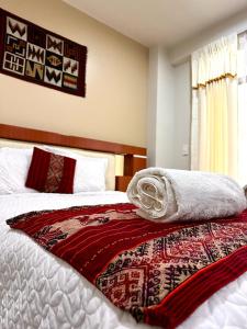 ein Schlafzimmer mit einem Bett mit einer Decke darauf in der Unterkunft LA CASA REAL in Puno