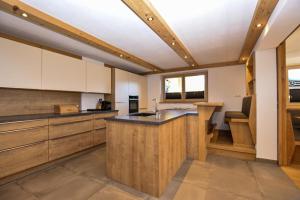 a kitchen with white cabinets and a counter top at Landhaus Kirchberg in Kirchberg in Tirol