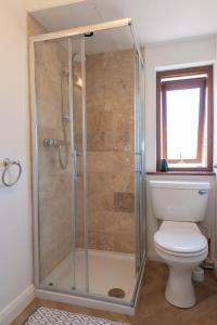 a bathroom with a shower and a toilet at Coastal Bungalow Near Marloes with Log Burner and Garden in Dale +45 photos