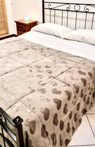 a bed with a blanket on top of it at MD HOUSE 2.0. CIVITAVECCHIA in Civitavecchia