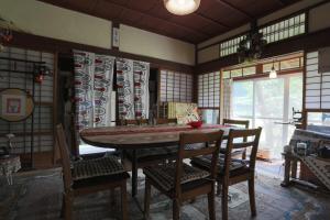 a dining room with a wooden table and chairs at 棚田ハウス 