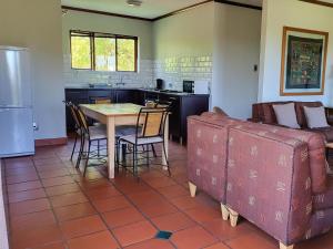 a kitchen and living room with a table and a couch at FamilyQuest Accommodation in White River