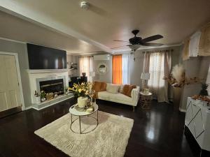 a living room with a couch and a fireplace at LifeTyme Homes 