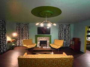 a living room with a couch and a fireplace at Chic 50s Time Capsule Downtown/OU Med/OK Capitol in Oklahoma City