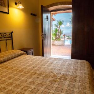 a bedroom with a bed and a door to a pool at Le Cese in San Giovanni Rotondo