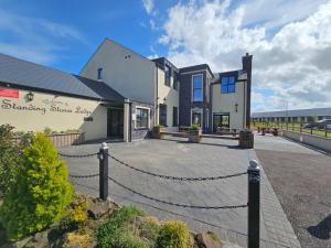 a house with a chain fence in front of it at Standing Stones Lodge in Belfast