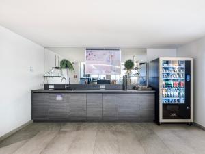 a kitchen with a refrigerator with drinks in it at numa I Viktoria Apartments in Munich