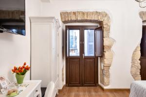 a door in a room with a stone wall at Baco B&B in Cagliari