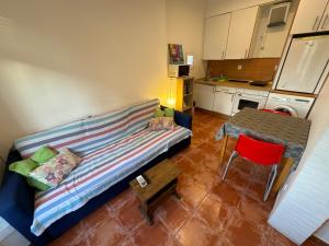 a living room with a couch and a table at Louie Louie Apartment Old Town in Tarragona