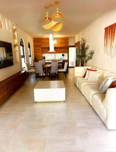 a living room with a couch and a table at VillaMaya- Hidden City Oasis in Mayaguez