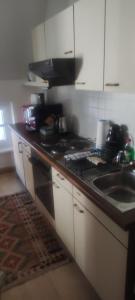 a kitchen with a counter top with a sink and a stove at ZENTRALE LAGE - Top 5 in Bad Ischl