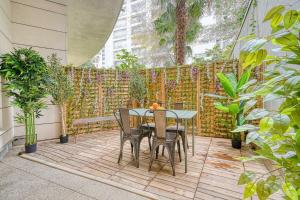 a table and chairs on a patio with plants at Eden Suite Paris la Defense in Courbevoie