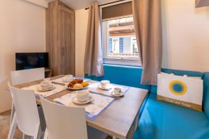 a dining room with a wooden table and chairs at Club del Sole Orbetello Family Collection in Orbetello
