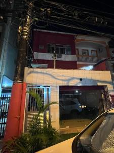 a car parked in front of a building at night at casa de praia in Santos