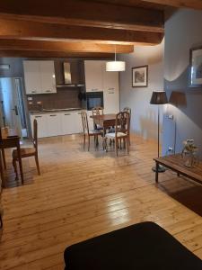 a kitchen and dining room with a table and chairs at Tenuta di Forte Sorgnano in Gualdo Cattaneo