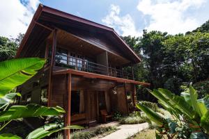 a wooden house in the middle of a forest at Cala Lodge in Monteverde Costa Rica