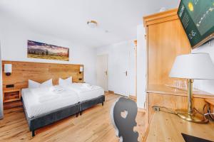Postel nebo postele na pokoji v ubytování Weidegg - Hotel Garni