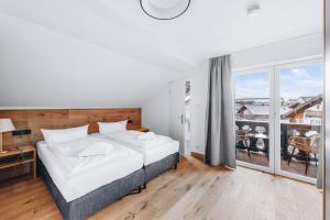 Postel nebo postele na pokoji v ubytování Weidegg - Hotel Garni