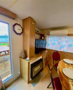 a kitchen with a table and a clock on the wall at impasse des Terres Fortes in Romorantin