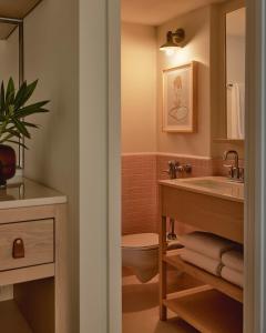 a bathroom with a sink and a toilet at Hotel Lucine in Galveston