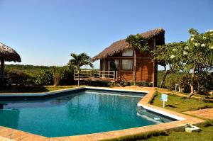 a swimming pool in front of a house at Ilha dos Poldros in Araioses