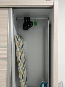 a door of a closet with a surfboard in it at Comfy 3BR Apartment Our Homestay Pusing Batu Gajah in Pusing