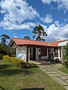 a white house with a red roof at Patio Bonito in Jardin