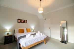 um quarto com uma cama king-size e um espelho em Charming House - Perfect For Long Stays em Bishop Auckland