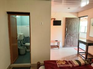 a living room with a door leading to a bathroom at Sunrise Villa Coorg in Madikeri