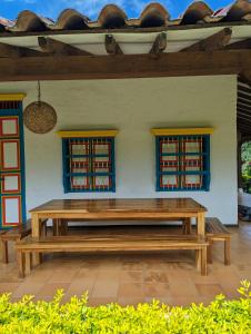 a wooden bench sitting in front of a building at Patio Bonito in Jardin