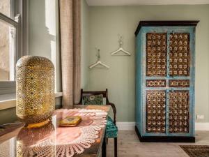 a room with a table and a blue door at Pass the Keys Garden View Period Dartmoor apartment with garden views in Chagford