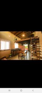 a living room with a table and a loft at Residencial Banzaê in Garopaba