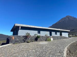 a house on a hill with a mountain in the background at Casa Ze & sonia in Portela