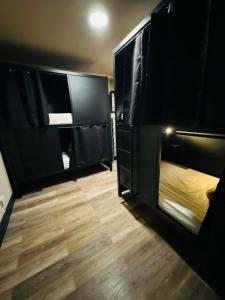 a room with black bunk beds and a wooden floor at KAMA CENTRAL PARK in New York